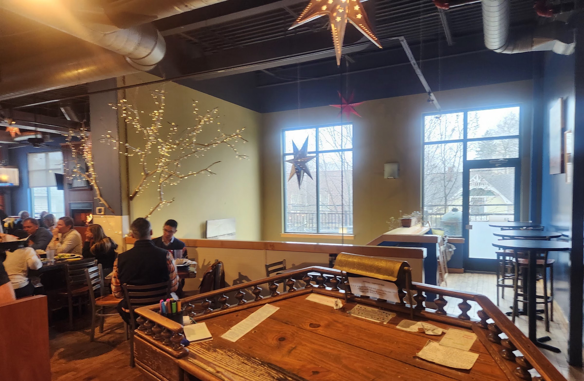 The dining room at night — pressed-tin ceiling, star lanterns, warm light